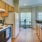 Kitchen open to dining space with large windows for natural light