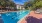 Lounge chairs beside a sparking blue lap pool